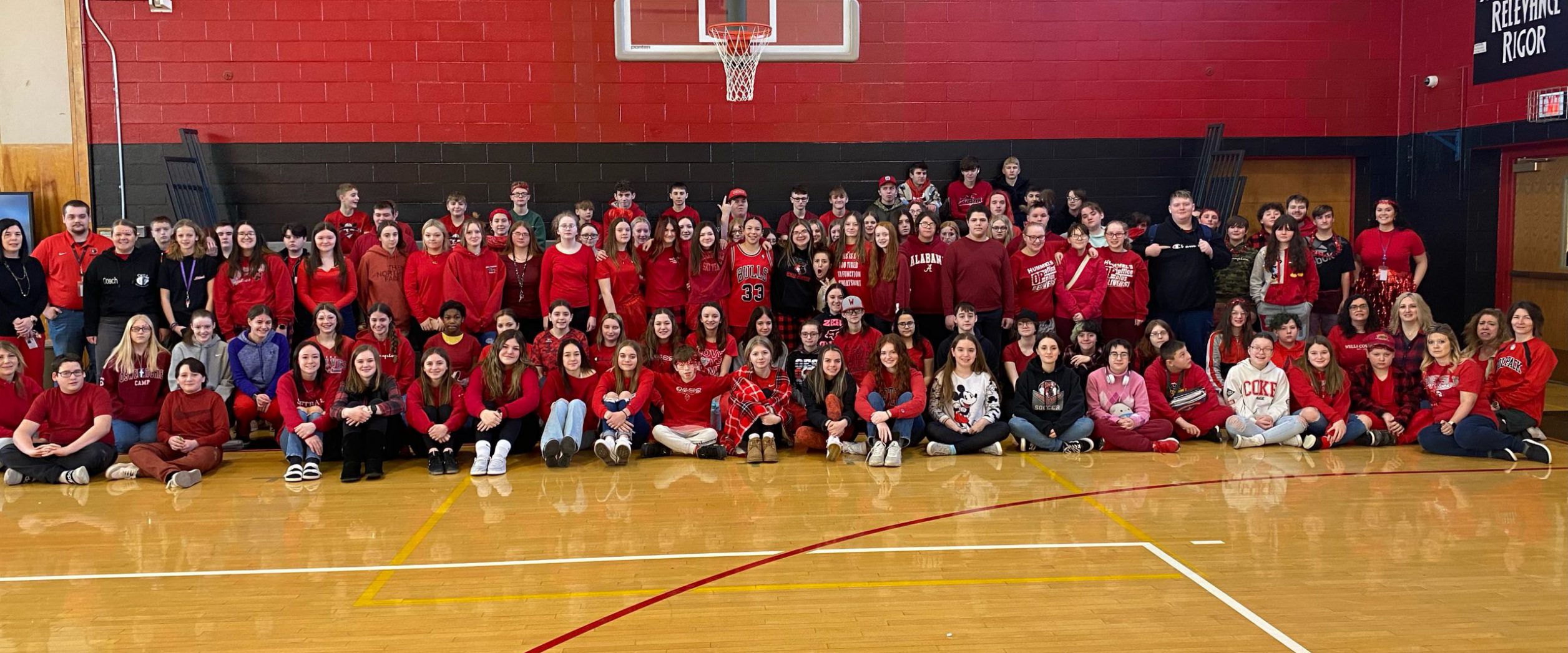 OESJ students and staff pose for a photo in the OESJ gymnasium.