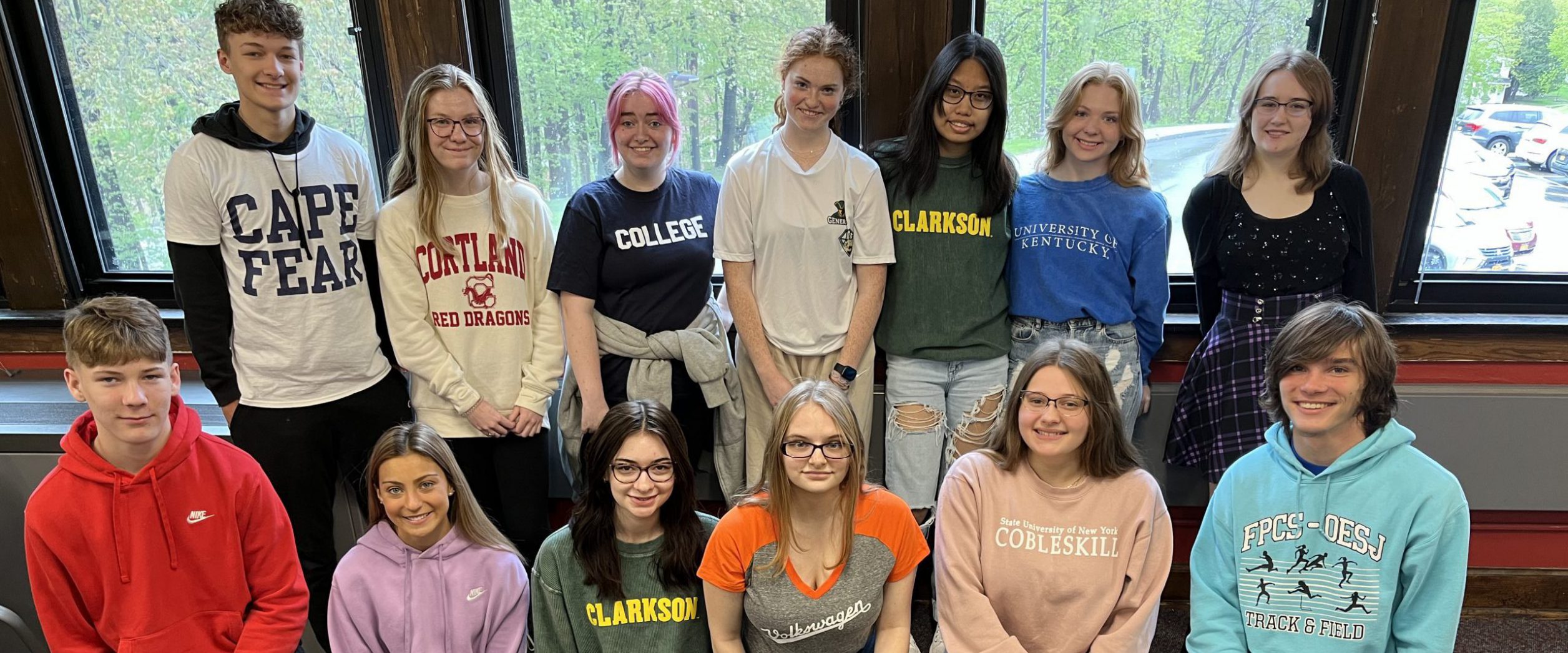 Students pose for a photo after committing to their college of choice on National College Decision Day