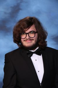 A snapshot of Kenneth Calabrese posing for his senior picture portrait.