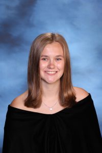 A snapshot of Sydney Hazzard posing for her senior picture portrait.