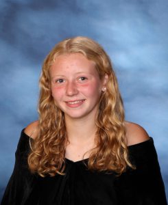 A snapshot of Kendall Przestrzelski posing for her senior picture portrait.