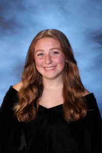 A snapshot of EmmaJo Schmidtmann posing for her senior picture portrait.