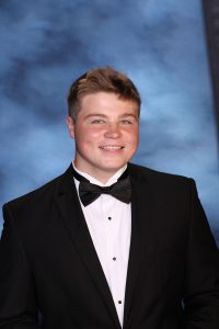 A snapshot of Dominic Taglialatela posing for his senior picture portrait.